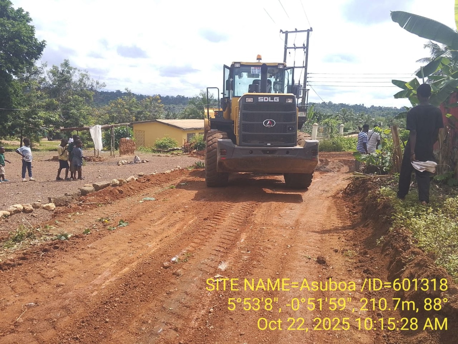 Motor grader carrying out access road improvement works